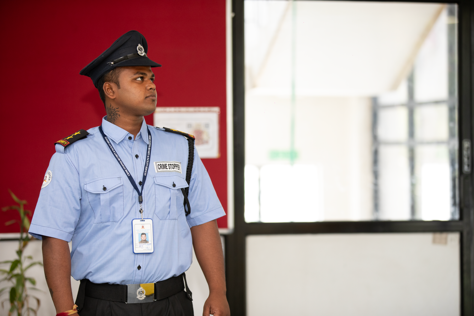Professional security guard standing alert at a building entrance